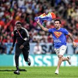 A pitch invader with a shirt reading "Save Ukraine" and a rainbow flag during Portugal vs Uruguay.  They risked it all to send the message   #FIFAWorldCup | #Qatar2022