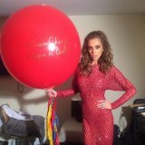 The English singer Cheryl with a personalized big balloon#cheryl #teamcheryl #xfactor #reddress #gala #elegantwoman #red #balloon