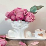 Photo by Derouich Fadwa on January 30, 2024. May be an image of vase, candle, flower arrangement, bust, rose and text.