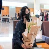 Jungkook holding the bouquet given to him by the hotel on arrival, showing off his shirt infront of the chartered plane, sitting in the stadium. He had such a great time!