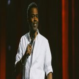 Turns out, Chris Rock is still really angry at Will and Jada Pinkett Smith. "...She hurt him way more than he hurt me," Rock said of Will Smith Saturday night during his live standup special for Netflix from Baltimore, Selective Outrage.