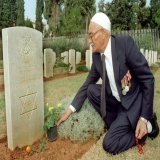 A 79-year-old Muslim Palestinian World War II veteran, Khaled Musa, lays flowers at the grave of his fellow Jew who died in action on July 23, 1943. Beirut, Lebanon, Nov. 14, 1999.