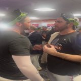 Justin Verlander and Trey Mancini embrace in the locker room.