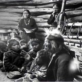 Seated close to the evening fire, 91-year old Navajo man, Gray Mountain, tells small children legends about the early days of the Navajo people. 1948. Photographed by, Leonard James McCombe, Photojournalist. (born June 1st, 1923, on the Isle of Man, 