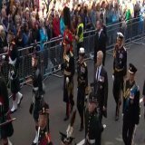 Queen Elizabeth's children, King Charles, Princess Anne, Prince Andrew and Prince Edward, stand in royal vigil beside her coffin in Edinburgh on Monday evening.