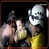 A young Syrian boy smiled and started to play with rescue workers who pulled him from the rubble of a building that was destroyed following deadly earthquakes in Turkey and Syria
