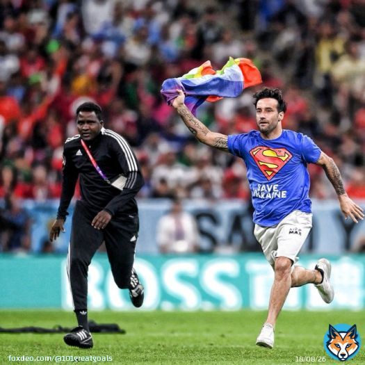 A pitch invader with a shirt reading 'Save Ukraine' and a rainbow flag during Portugal vs Uruguay.  They risked it all to send the message   #FIFAWorldCup | #Qatar2022