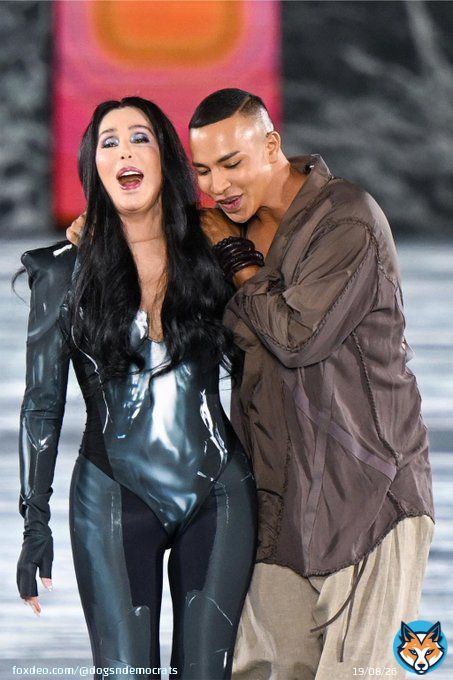How about 76 year old Cher appearing at Paris Fashion Week in latex bodysuit, black platform boots & gloves, closing Balmain runway show with creative director Olivier Rousteing.