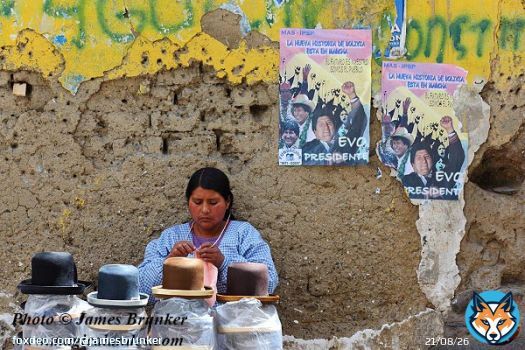 A lady selling bowler hats in a street market in La Paz #Bolivia for #NationalHatDay, available as prints cards and #gifts here:  #AYearForArt #BuyIntoArt #GiftThemArt #BuyArtNotCandy #HatDay #hats #markets #LaPaz #traditionaldress #streetphotography