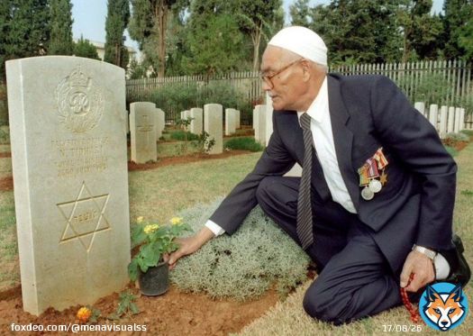 A 79-year-old Muslim Palestinian World War II veteran, Khaled Musa, lays flowers at the grave of his fellow Jew who died in action on July 23, 1943. Beirut, Lebanon, Nov. 14, 1999.
