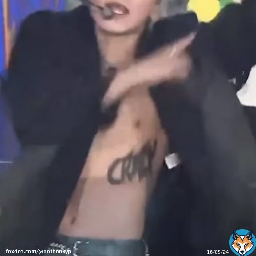 san is shirtless with “crazy” tattoo on his left side