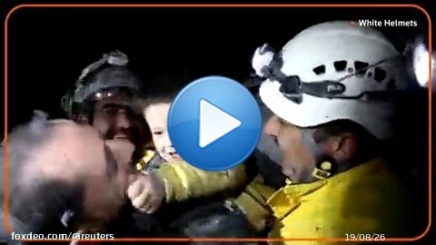 A young Syrian boy smiled and started to play with rescue workers who pulled him from the rubble of a building that was destroyed following deadly earthquakes in Turkey and Syria