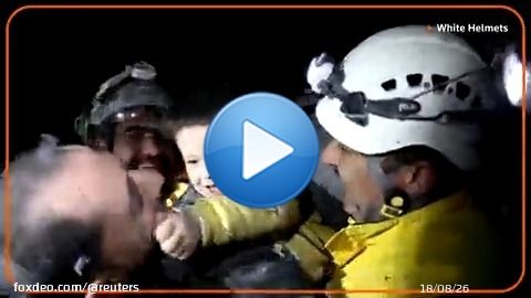 A young Syrian boy smiled and started to play with rescue workers who pulled him from the rubble of a building that was destroyed following deadly earthquakes in Turkey and Syria