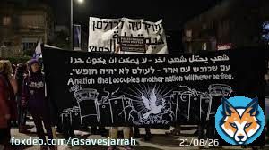 A black sign depicts the separation barrier, guard towers and barbed wire that contain the West Bank; in the middle, a dove bearing an olive branch. &ldquo;A nation that occupies another nation will never be free,&rdquo; says the sign in Arabic, Hebrew and English. #IsraeliApartheid