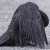 This crow has allowed itself to be covered in ants   Birds engage in a fascinating behavior called anting, where they rub insects, especially ants, on their feathers and skin. This can be done actively by picking up insects and applying them to their