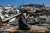 A man prays atop destroyed home in Hatay, Turkiye  - the site of a second 6.4M earthquake yesterday