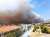 The fire just outside #Athens has now reached the National Road that circles the city, authorities closed the road near Elefsina. #&Alpha;&tau;&tau;&iota;&kappa;ή The wind here is just terrible, all night it gusted so strongly there are ripped awning