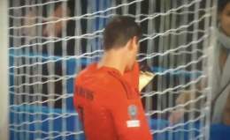 Courtois kissing the Real Madrid badge in front of Chelsea supporters.