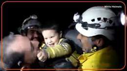 A young Syrian boy smiled and started to play with rescue workers who pulled him from the rubble of a building that was destroyed following deadly earthquakes in Turkey and Syria