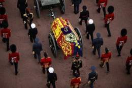Draped in the Royal Standard, Her Majesty The Queen's coffin is taken in Procession to Westminster Hall.